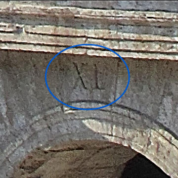 XL carved above one of the Colosseum's arched entrances.